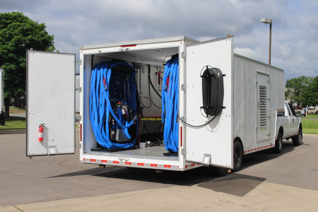 Spray foam rig trailer with proportioner and heated hose